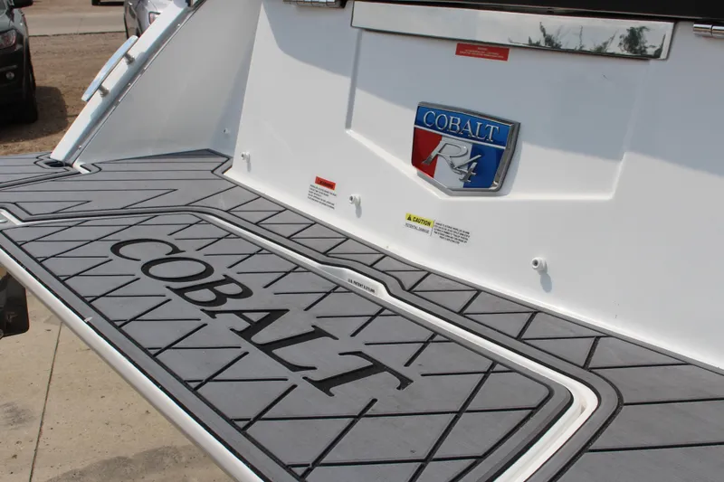 Slide: The Image of 2025 Cobalt R4 Surf boat deck with logo and branding details. - 8