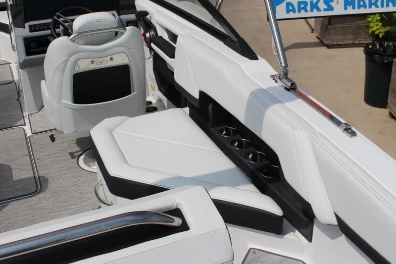 Slide: The Image of 2025 Cobalt R4 Surf boat interior with white seating and cup holders. - 9