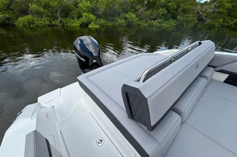Slide: The Image of 2026 Cobalt R4 Outboard boat with Mercury engine, featuring sleek seating and lush greenery backdrop. - 11