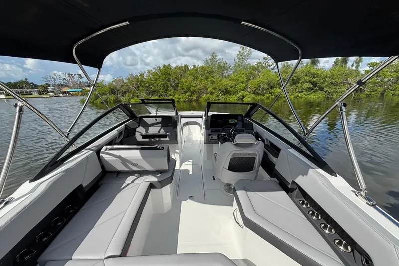 Slide: The Image of 2026 Cobalt R4 Outboard boat interior with sleek seating and modern dashboard on a calm lake. - 6