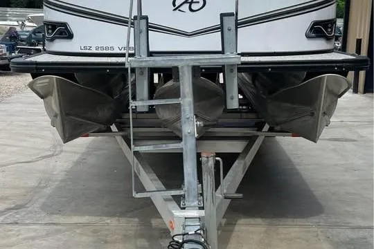 Slide: The Image of 2024 Avalon LSV 2585 pontoon boat on trailer, rear view. - 10