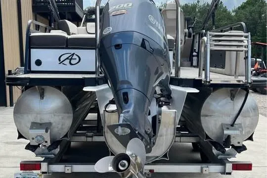 Slide: The Image of 2024 Avalon LSV 2585 pontoon boat with powerful outboard motor on trailer. - 11