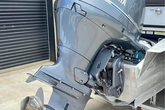 Slide: The Image of 2024 Avalon LSV 2585 boat with powerful outboard motor in a garage setting. - 16