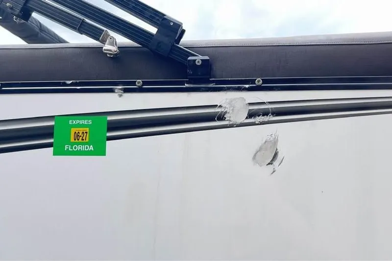 Slide: The Image of 2024 Avalon LSV 2585 with Florida registration sticker and visible damage on the side. - 17