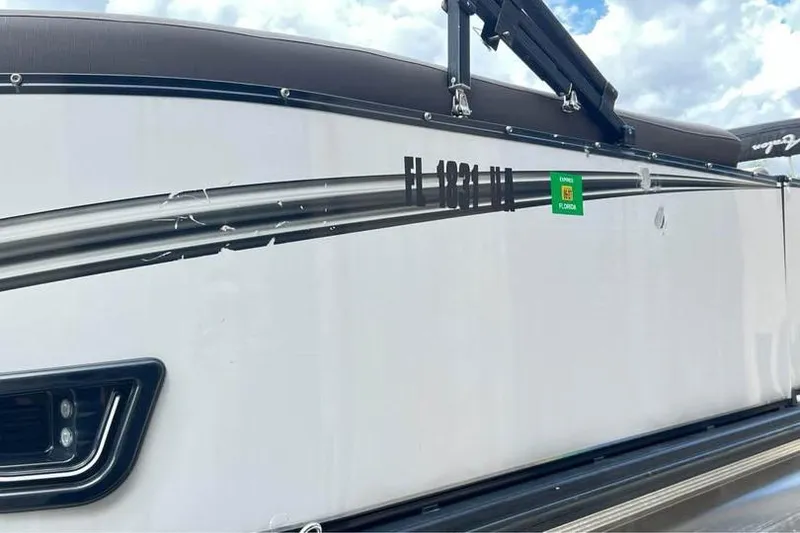 Slide: The Image of 2024 Avalon LSV 2585 boat side view with Florida registration sticker. - 18