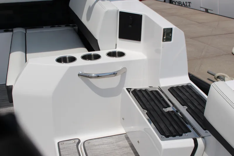Slide: The Image of 2025 Cobalt R31 Surf boat interior with cup holders and seating area. - 11