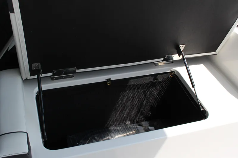 Slide: The Image of Open storage compartment in 2025 Cobalt R31 Surf boat, showcasing interior space. - 14