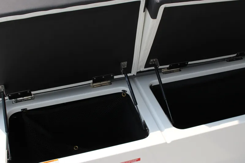 Slide: The Image of Open storage compartments on a 2025 Cobalt R31 Surf boat. - 15