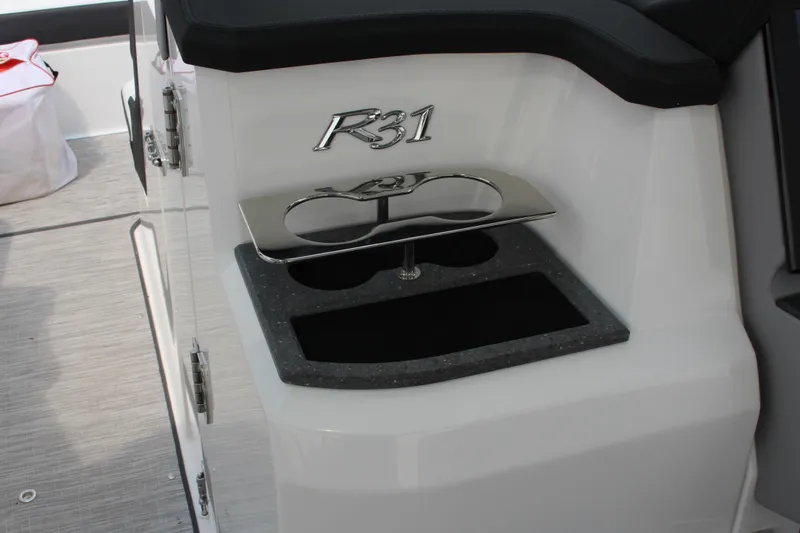Slide: The Image of 2025 Cobalt R31 Surf boat interior with cup holder and sleek design. - 19