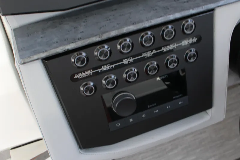 Slide: The Image of Control panel of 2025 Cobalt R31 Surf boat with multiple switches and dials. - 21