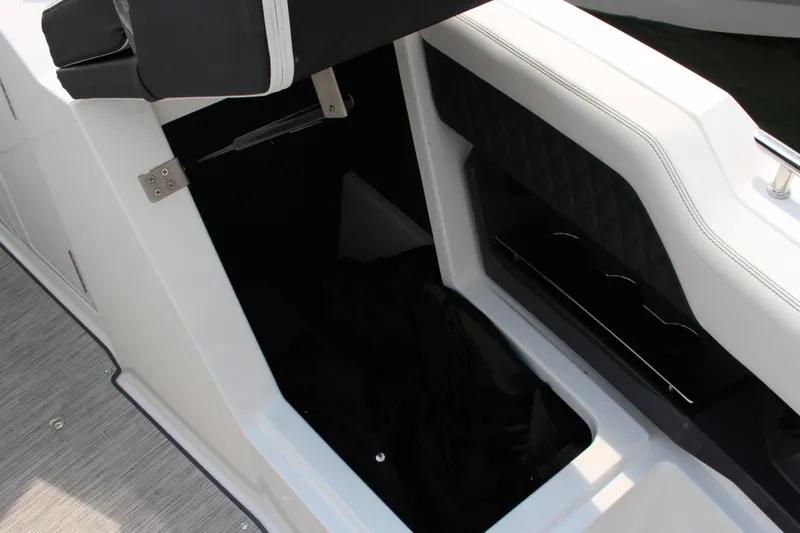 Slide: The Image of 2025 Cobalt R31 Surf boat interior storage compartment with cushioned seating. - 29
