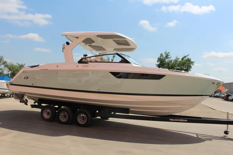 Slide: The Image of 2025 Cobalt R31 Surf boat on trailer under clear blue sky. - 3