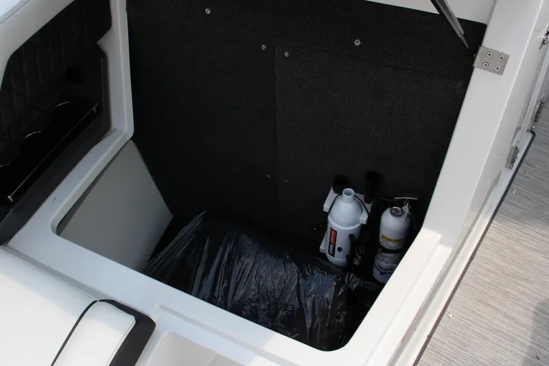 Slide: The Image of Storage compartment in 2025 Cobalt R31 Surf boat with safety equipment. - 30