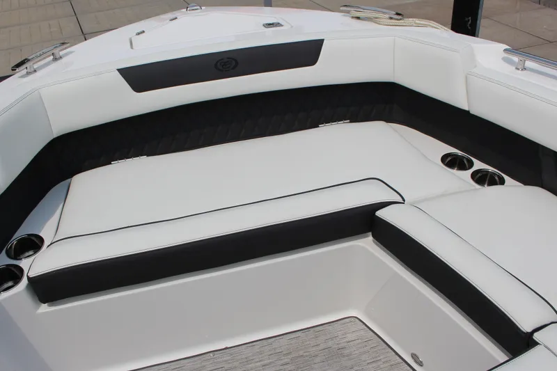 Slide: The Image of 2025 Cobalt R31 Surf boat interior with white and black seating, cup holders. - 31