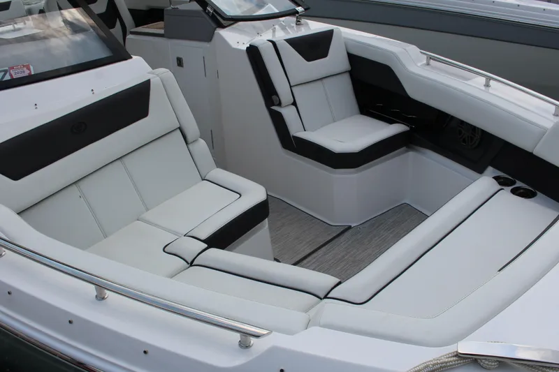 Slide: The Image of Luxurious seating on 2025 Cobalt R31 Surf boat, featuring sleek white and black upholstery. - 36