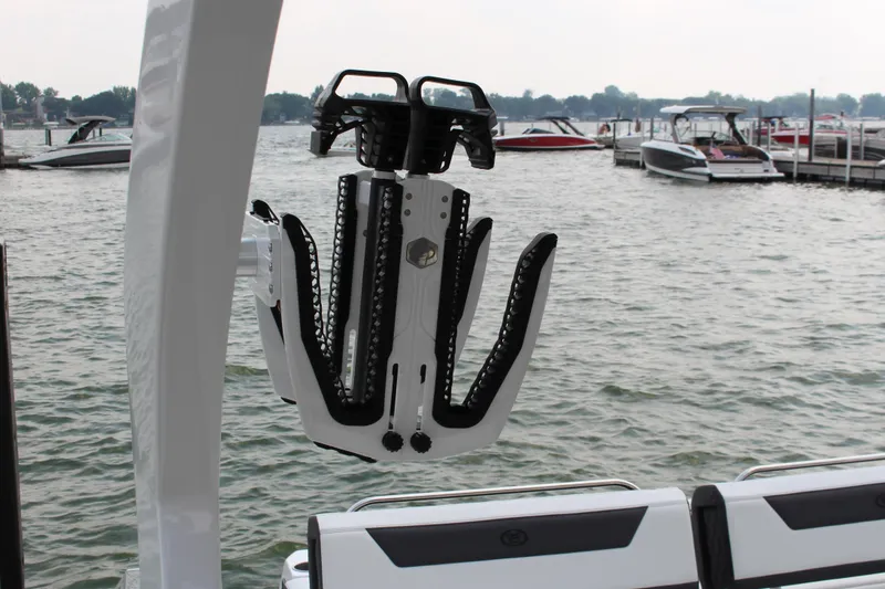 Slide: The Image of Wakeboard rack on 2025 Cobalt R31 Surf boat, docked by the water. - 38