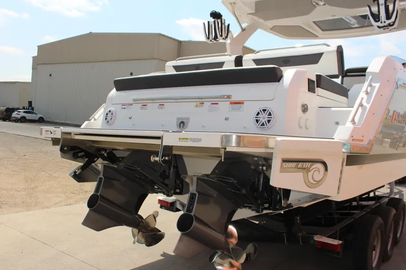 Slide: The Image of 2025 Cobalt R31 Surf boat rear view with dual propellers and sleek design. - 4