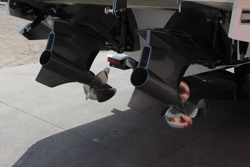 Slide: The Image of 2025 Cobalt R31 Surf boat propellers and outdrives on a concrete surface. - 44