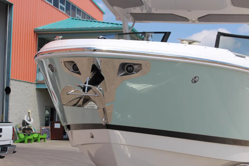 Slide: The Image of 2025 Cobalt R31 Surf boat with sleek design and chrome anchor detail. - 45