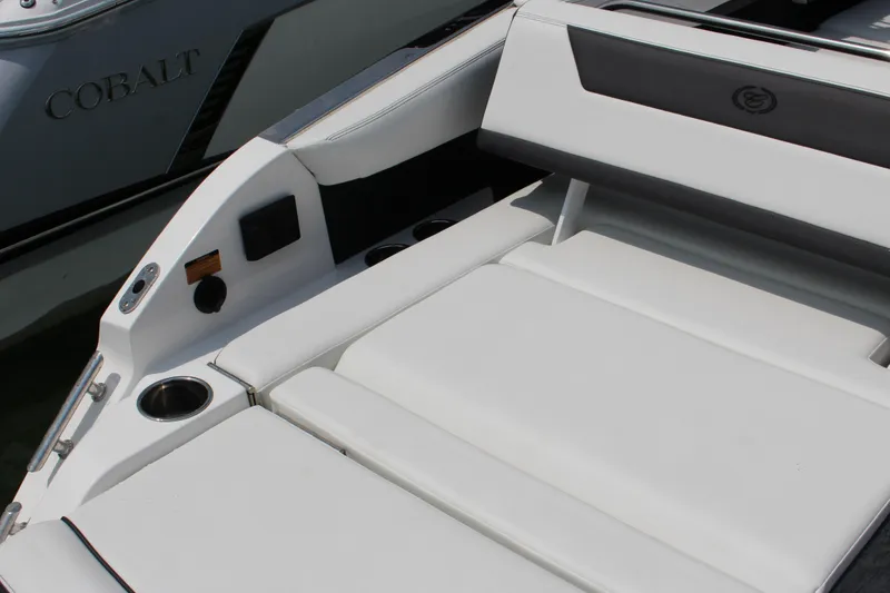Slide: The Image of 2025 Cobalt R31 Surf boat interior with sleek white seating and cup holders. - 8