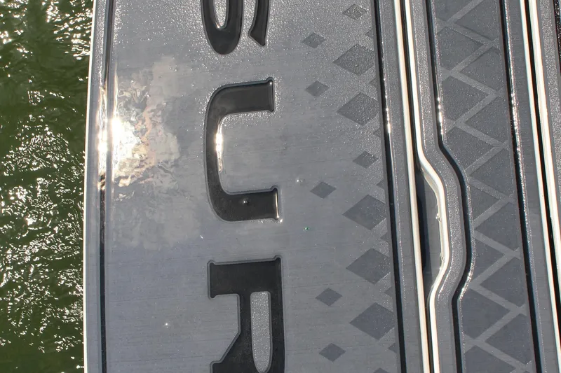 Slide: The Image of Close-up of 2025 Cobalt R31 Surf boat deck with textured design. - 9