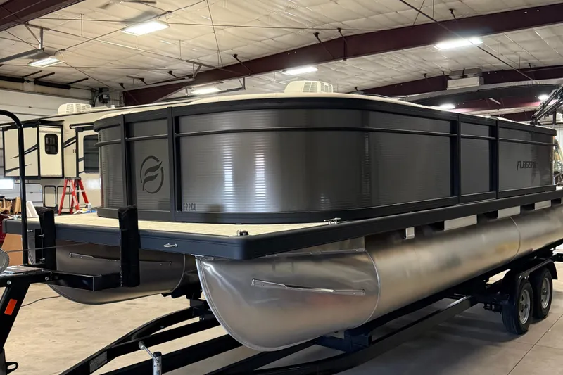 Slide: The Image of 2025 Flagship F22CU pontoon boat in a warehouse setting. - 1