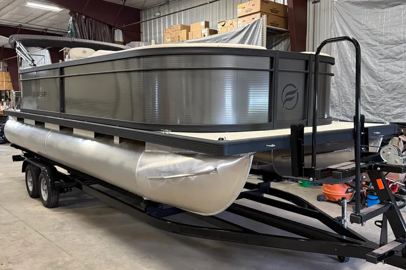 Slide: The Image of 2025 Flagship F22CU pontoon boat in a warehouse, showcasing sleek design and modern features. - 2