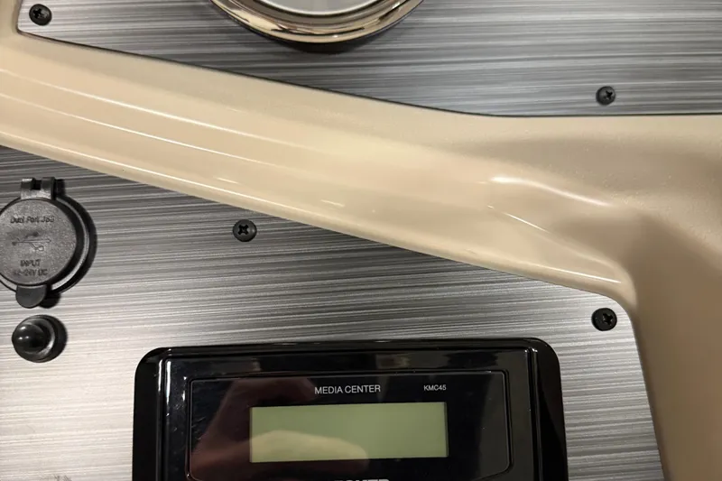 Slide: The Image of Captain's seat and dashboard of 2025 Flagship F22CU boat, featuring modern controls and steering. - 9