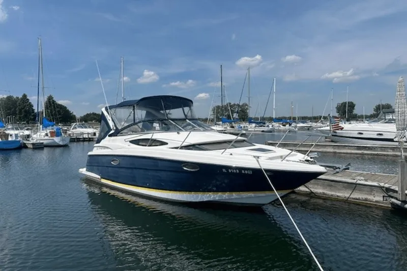 The Image of 2008 Regal 2860 Window Express boat docked in a marina under a clear sky. - 0