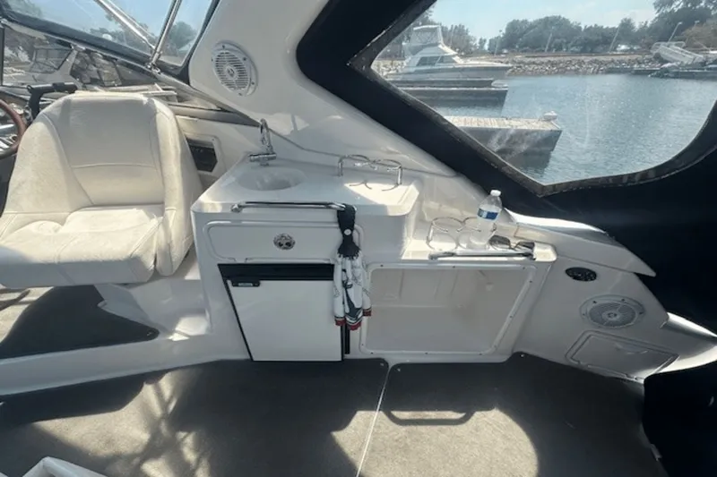 Slide: The Image of 2008 Regal 2860 Window Express boat interior with seating, sink, and storage. - 10