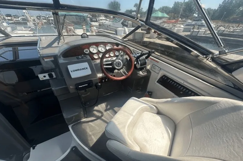Slide: The Image of 2008 Regal 2860 Window Express boat cockpit with steering wheel and navigation equipment. - 14