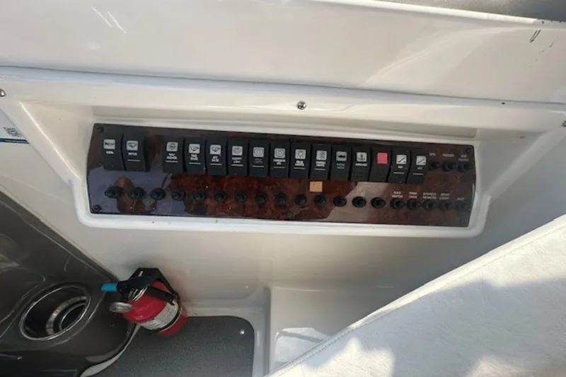 Slide: The Image of Control panel of a 2008 Regal 2860 Window Express boat with switches and fire extinguisher. - 16