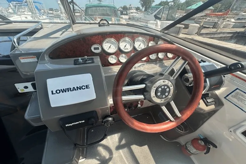 Slide: The Image of 2008 Regal 2860 Window Express boat dashboard with steering wheel and navigation equipment. - 17
