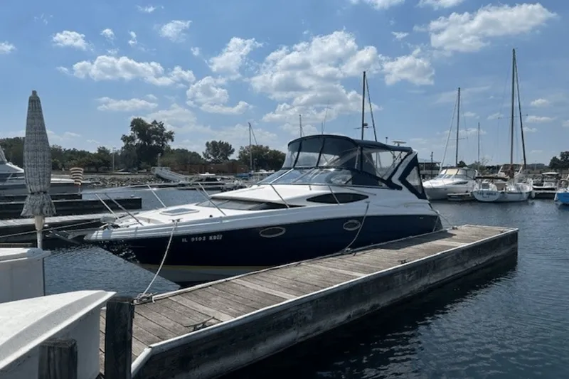 Slide: The Image of 2008 Regal 2860 Window Express boat docked at marina under blue sky. - 3
