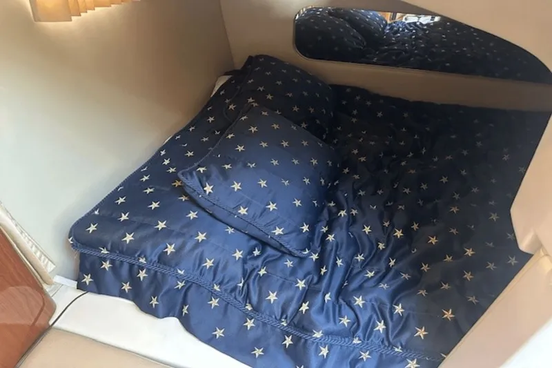 Slide: The Image of Cozy cabin bed with star-patterned bedding in 2008 Regal 2860 Window Express boat. - 31