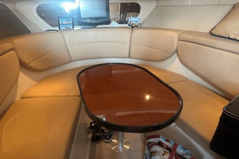 Slide: The Image of Interior of 2008 Regal 2860 Window Express with beige seating and wooden table. - 32