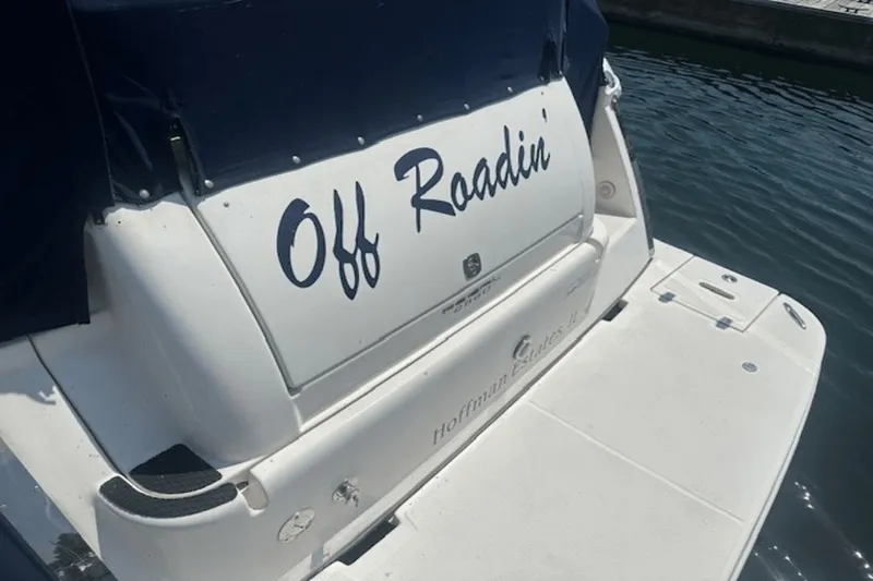 Slide: The Image of 2008 Regal 2860 Window Express boat named "Off Roadin" docked by the water. - 5
