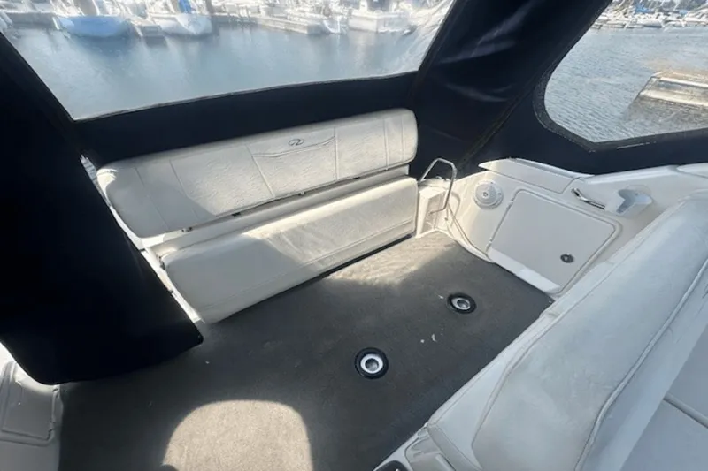 Slide: The Image of Interior of a 2008 Regal 2860 Window Express boat with seating and marina view. - 7