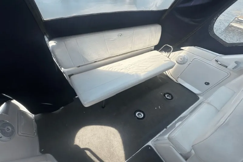 Slide: The Image of 2008 Regal 2860 Window Express boat interior with white seating and carpeted floor. - 8