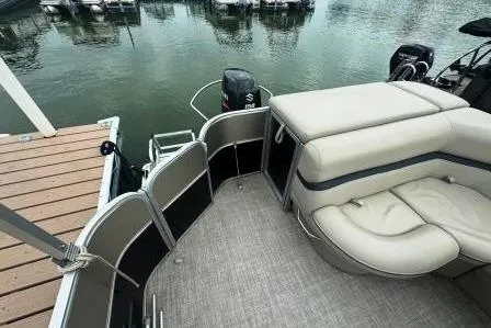 Slide: The Image of 2017 Berkshire 22CL CTS pontoon boat interior with seating, docked by the water. - 10