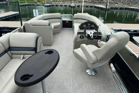Slide: The Image of 2017 Berkshire 22CL CTS pontoon boat interior with plush seating and steering console. - 12