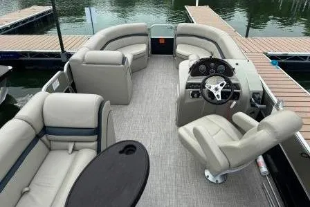 Slide: The Image of 2017 Berkshire 22CL CTS pontoon boat interior with plush seating and steering console. - 13