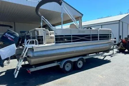 Slide: The Image of 2017 Berkshire 22CL CTS pontoon boat on trailer, parked outdoors. - 2
