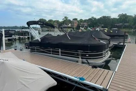 Slide: The Image of 2017 Berkshire 22CL CTS pontoon boat docked with cover on a calm lake. - 3