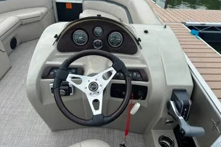 Slide: The Image of 2017 Berkshire 22CL CTS boat dashboard with steering wheel and gauges. - 7