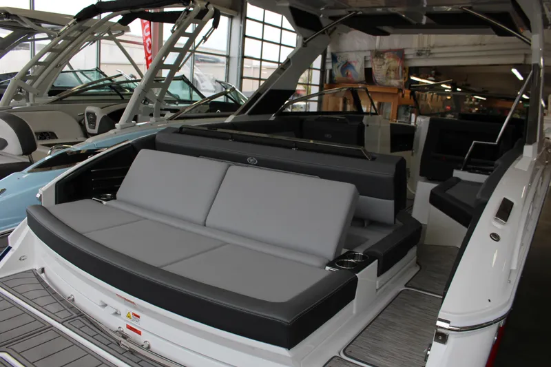 Slide: The Image of 2025 Cobalt A29 boat interior with luxurious seating in a showroom setting. - 7