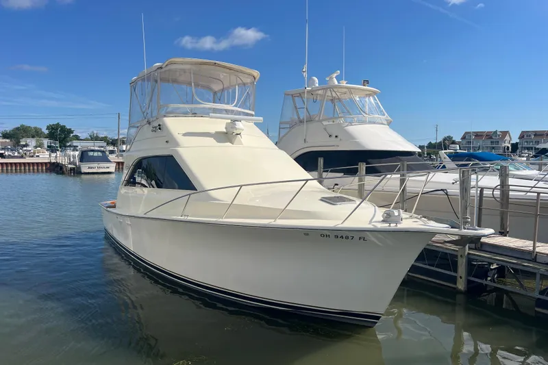 Slide: The Image of 1990 Ocean Yachts 35 Sport Sedan docked at marina under clear blue sky. - 0