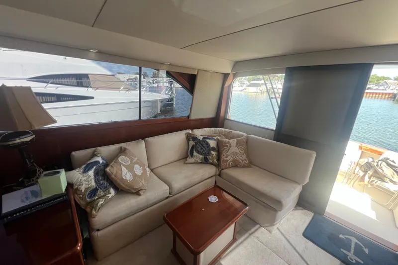 Slide: The Image of Interior of 1990 Ocean Yachts 35 Sport Sedan with cozy seating and marina view. - 13