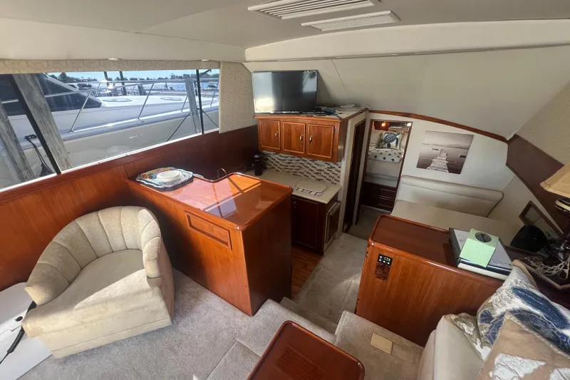 Slide: The Image of Interior of 1990 Ocean Yachts 35 Sport Sedan with cozy seating and wooden cabinetry. - 14