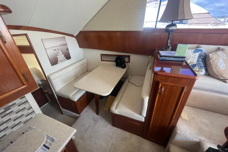 Slide: The Image of Interior of 1990 Ocean Yachts 35 Sport Sedan with dining area and cozy seating. - 16